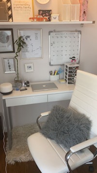 a white office with a white chair and a white wall